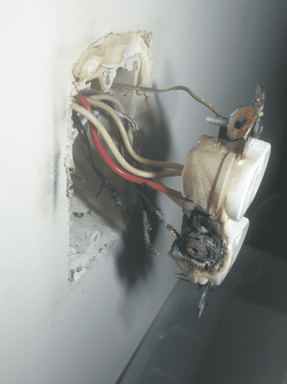 An outlet that has failed and begun to melt.