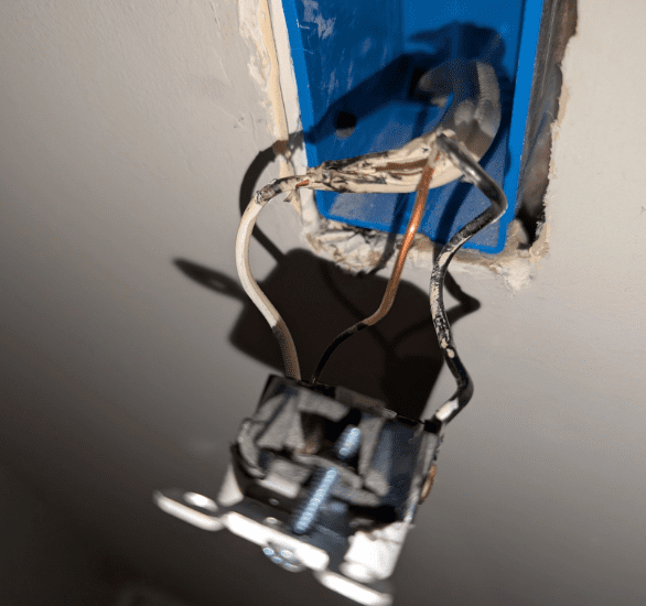 a set of wire that has begun to melt due to improper wiring or an overload on the circuit .