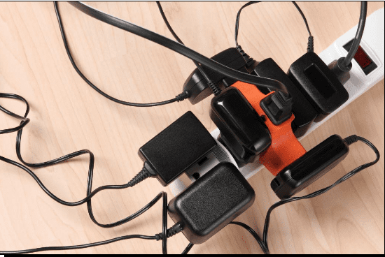 A power strip with to many things pugged into it, causing a circuit overload.